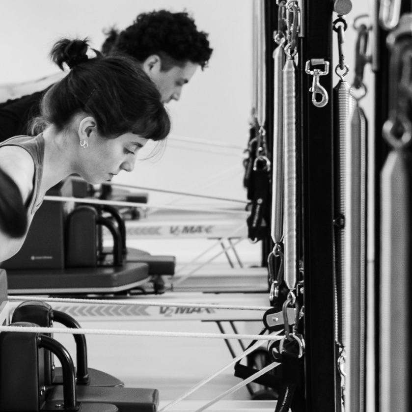 Strength building in Pilates reformer training. Young athletes mobilise their bodies with Pilates equipment training to build up their base in active sport.